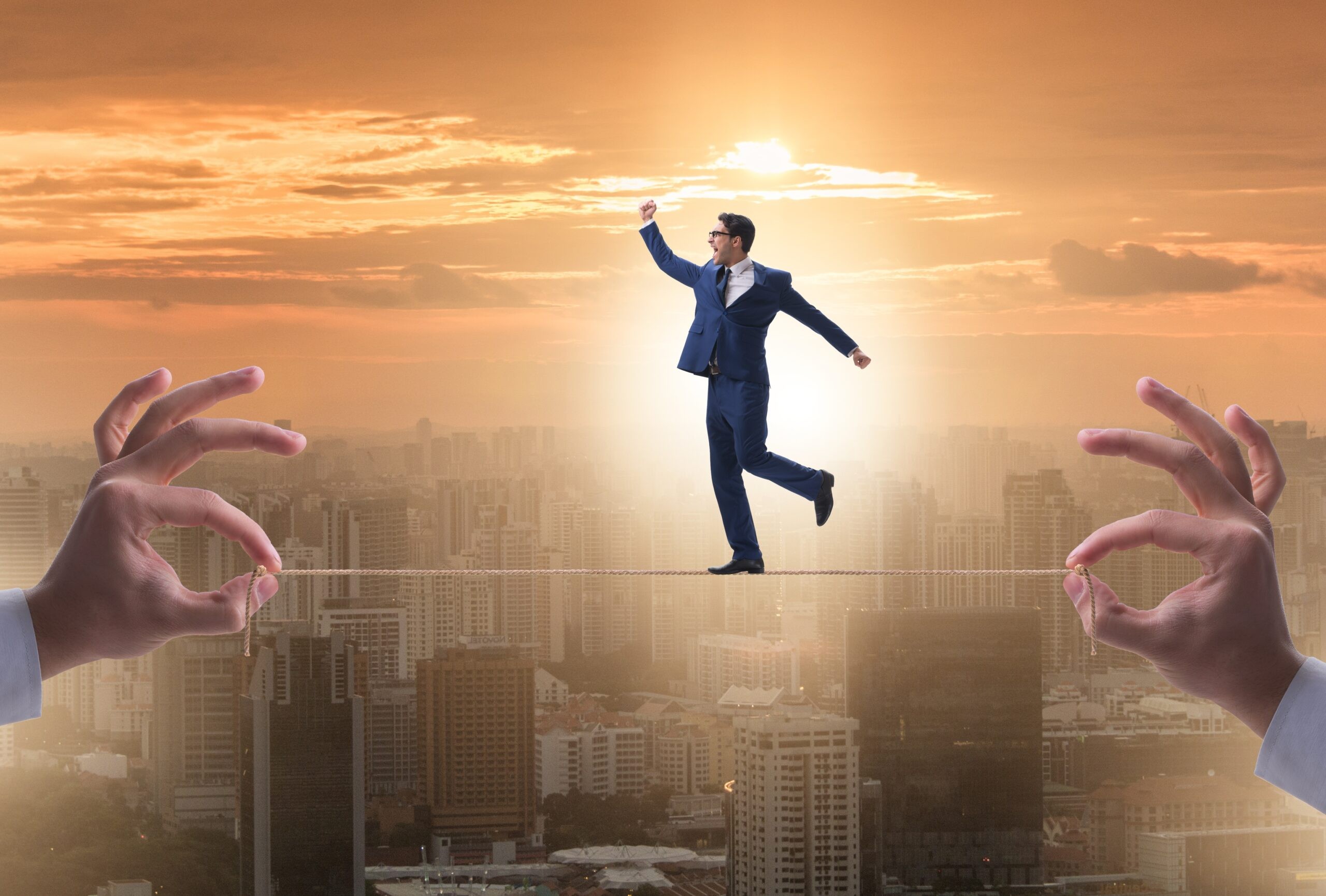 The businessman walking on tight rope Businessman walking on tight rope